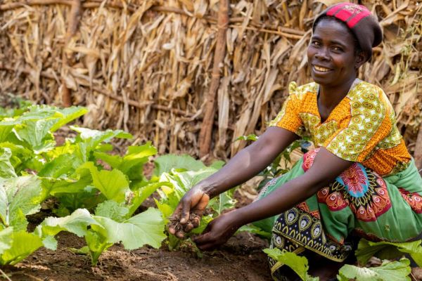 Fyness Tembo tending to her garden in Malawi