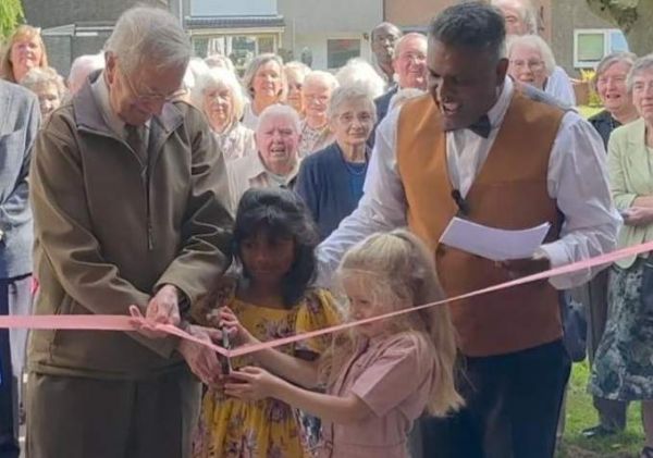 The oldest and youngest members of Hope Church perform the official opening as the church is renamed