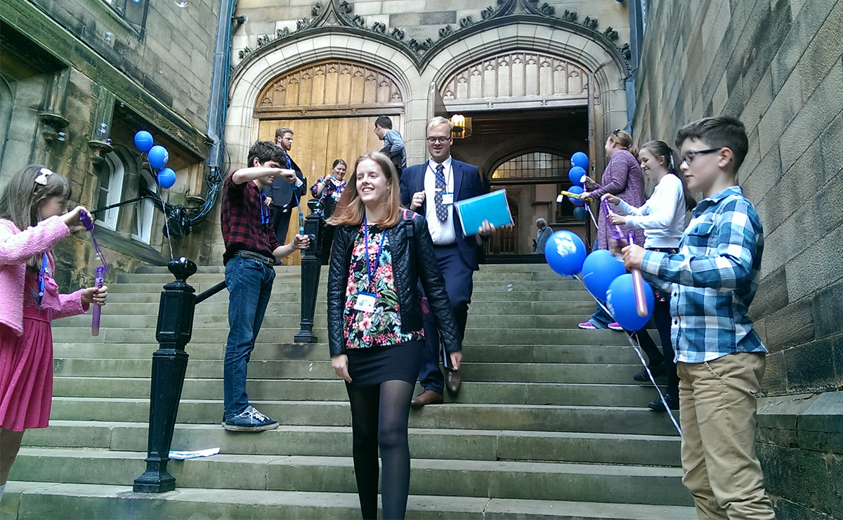 Young people blowing bubbles at the General Assembly