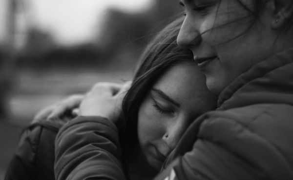 Woman embracing teen girl