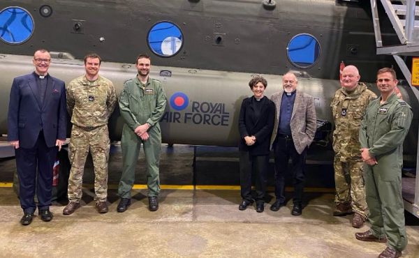 Moderator of the General Assembly of the Church of Scotland Rt Rev Sally Foster-Fulton with her tour companions in front of a Chinook helicopter.