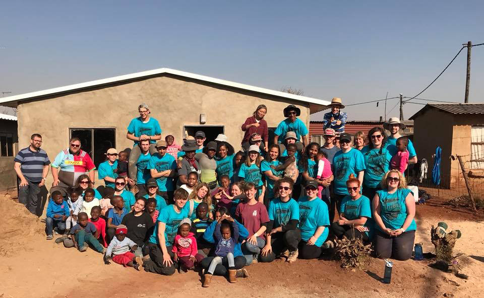 The group in front of one of the new houses.