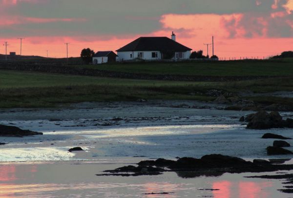 The manse of Tiree Parish Church at sunset