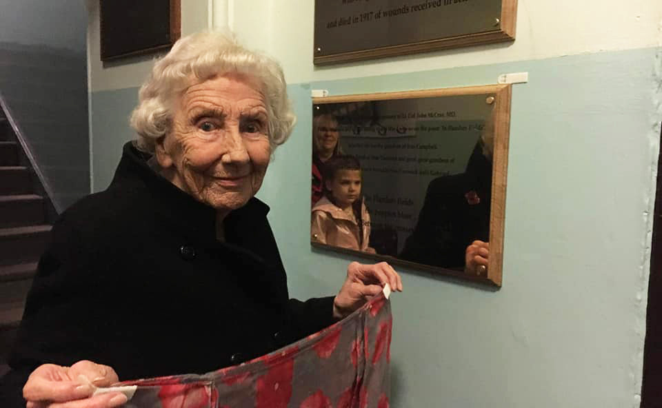 Ina McHattie, whose two uncles were killed in WWI, unveils the plaque dedicated to John McCrae