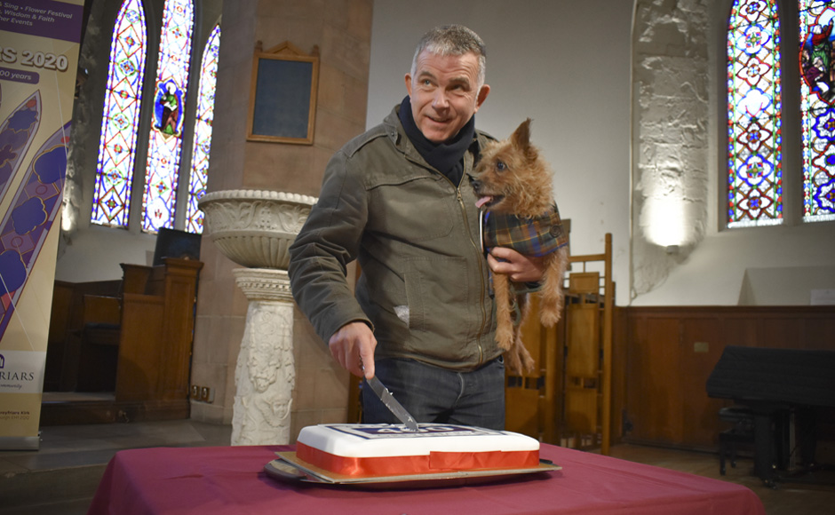 Tommy from the Grassmarket Project with Brillo the dog. Brillo is wearing Greyfriars tartan.