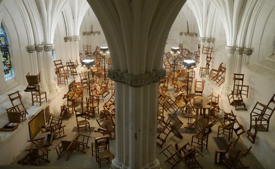 Image shows 122 chairs within the 'I will learn to sit with you and I will learn to listen'
