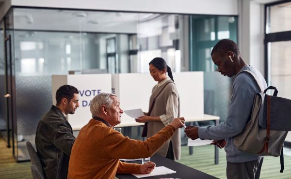 An Elderly Man Talking to a Voter
