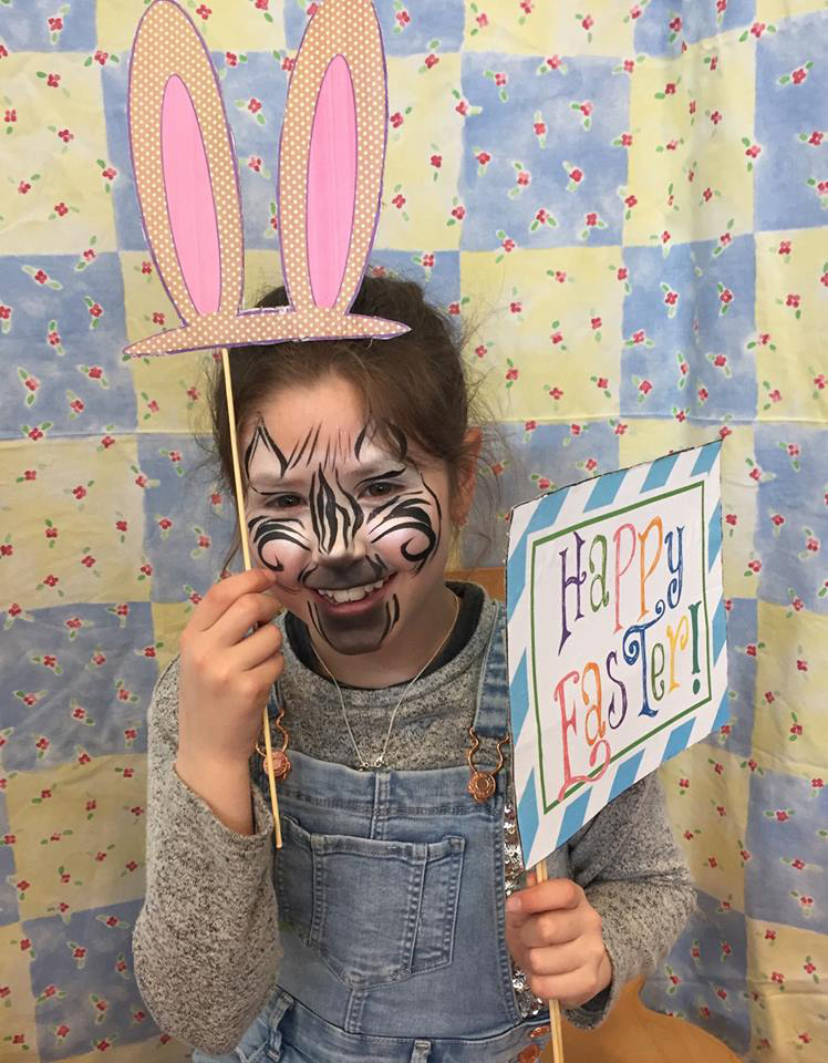 Young person wearing bunny ears for Easter