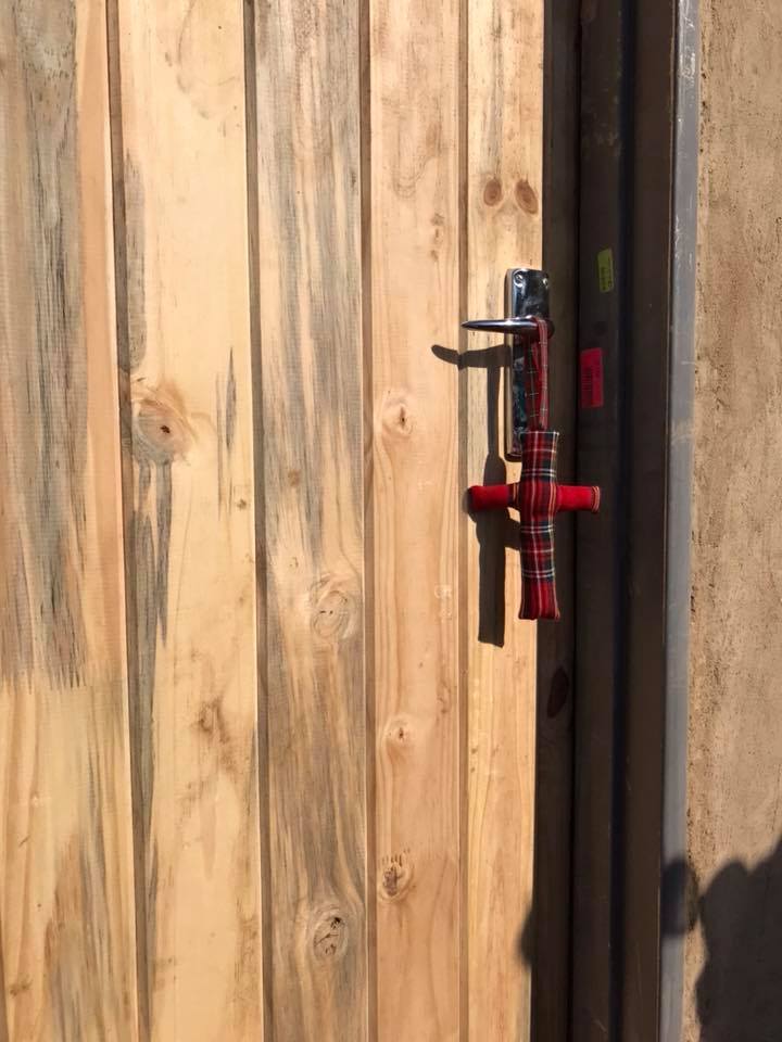 Leaving a touch of Scotland in the form of a tartan cross on the door of one of their houses.