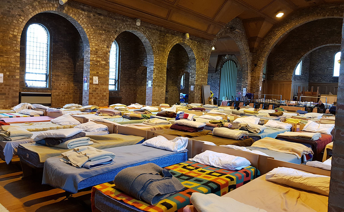 Beds lined up in a church
    