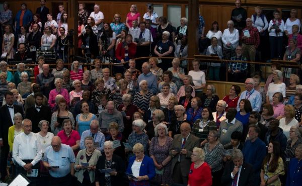 A group of Guild members singing in the Assembly Hall