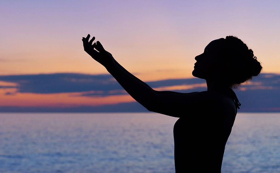 Woman raising arms towards sky