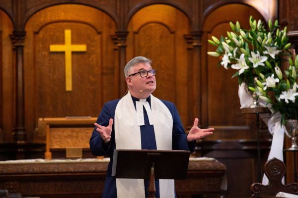 Rev Scott Rennie leads a service at Crown Court Church