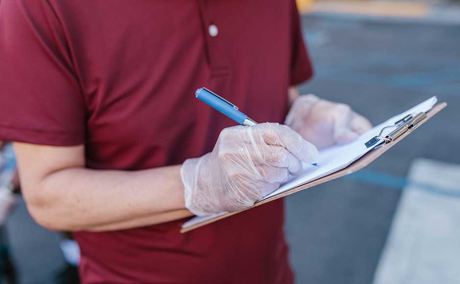 Gloved Person With Clipboard