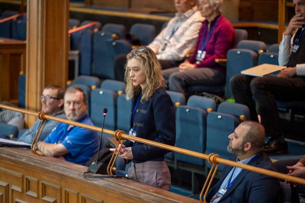 A young attendee addresses the General Assembly