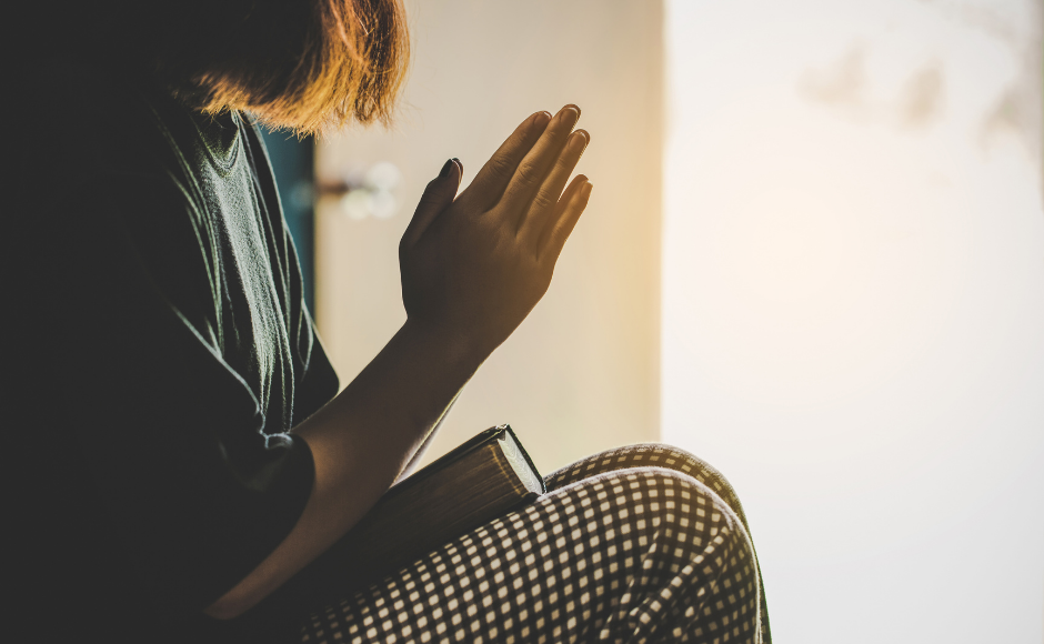 Woman praying with a Bible