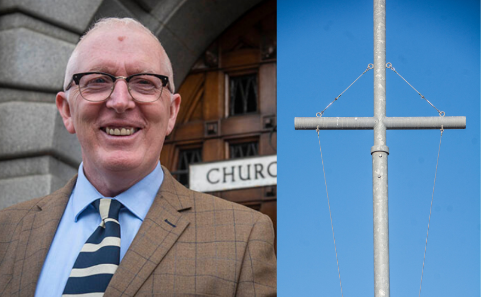 Rt Rev Dr Martin Fair next to an image of the Cross.