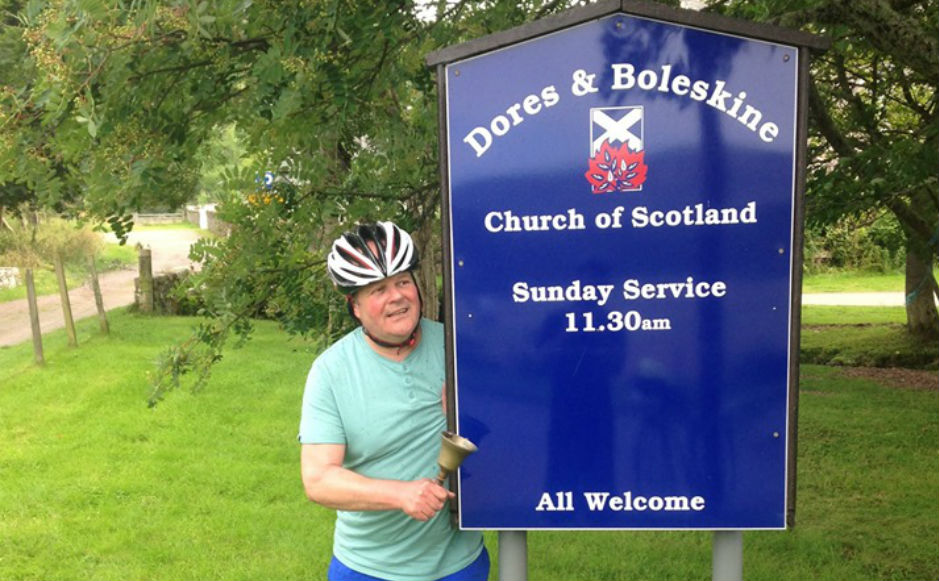 Rev Robert Brookes ringing a hand bell at Dores and Boleskine Church 