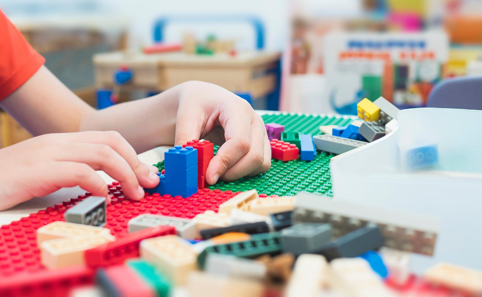 Child's hands playing with lego