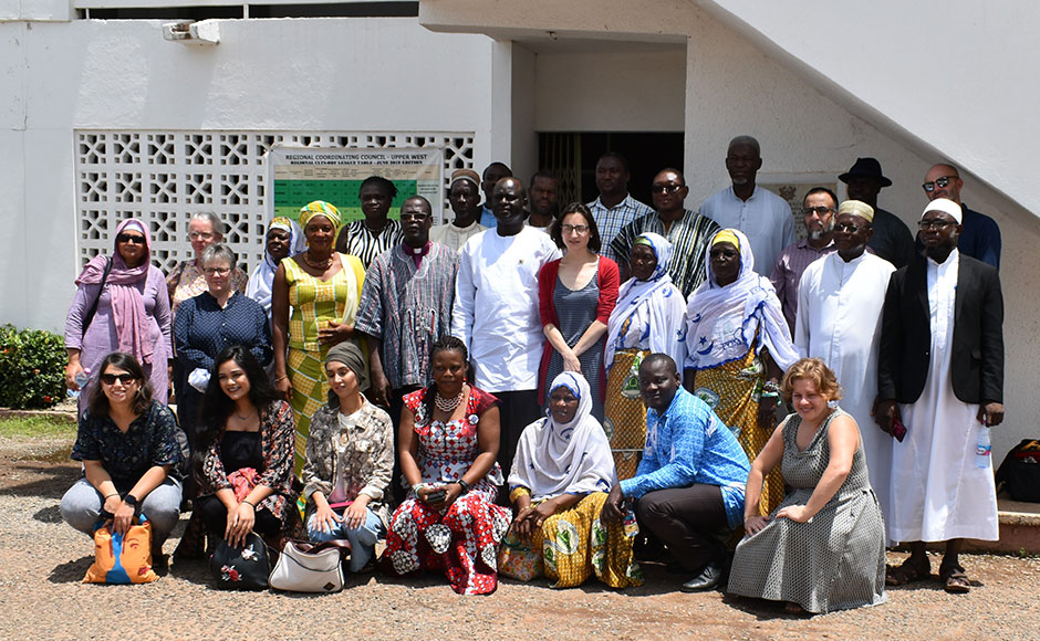 A group of people of different races and faiths gathered outside