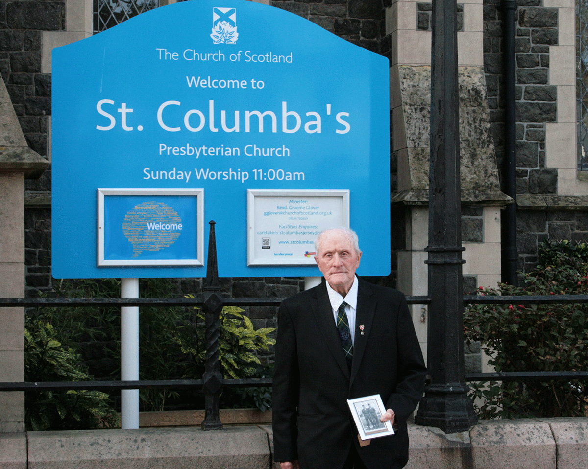 Ex-serviceman Sandy Wright holding a photo of him and his friend Scott during his service days in the 1950s.