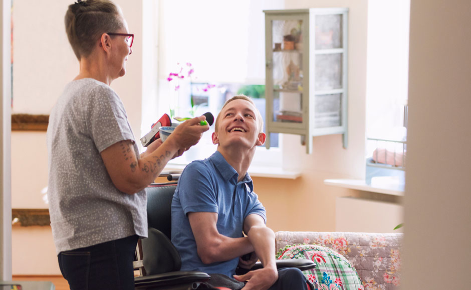 woman with young man in power chair