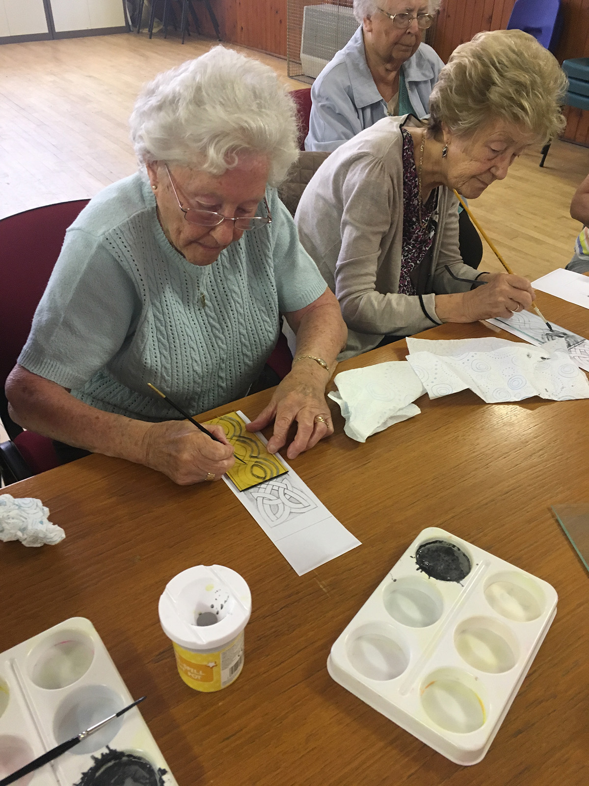 Two members of the senior adult group trying glass painting