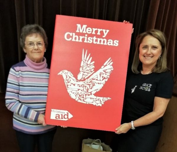 Iris Nelson and Janis McBride, members of St John’s Parish Church, holding the card.