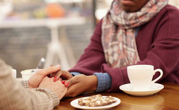 Woman holding someone's hand in comfort