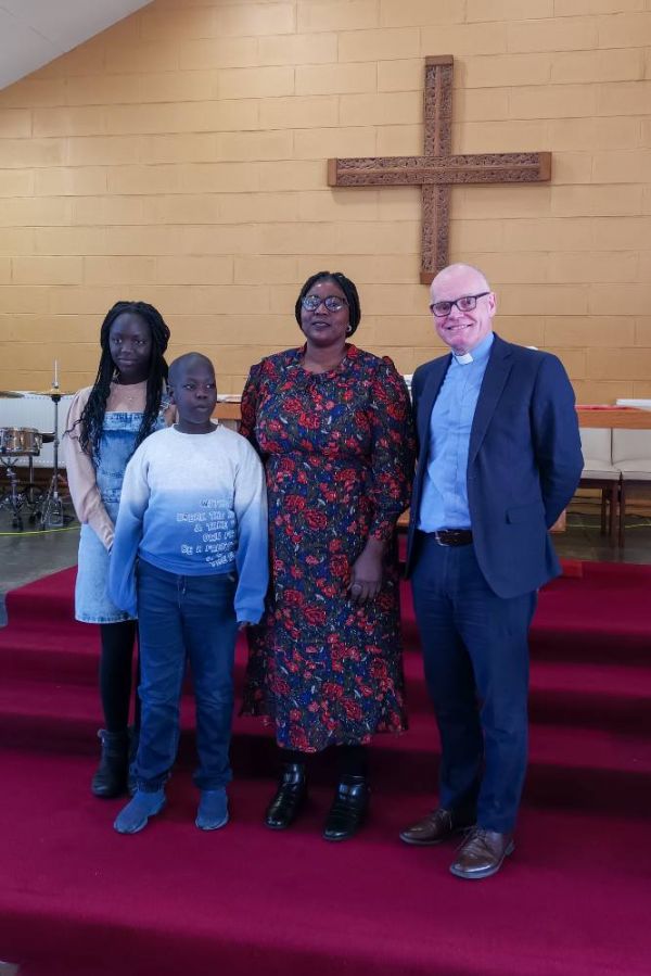 Eman Musa with children Shire and David and minster Rev Barry Hughes