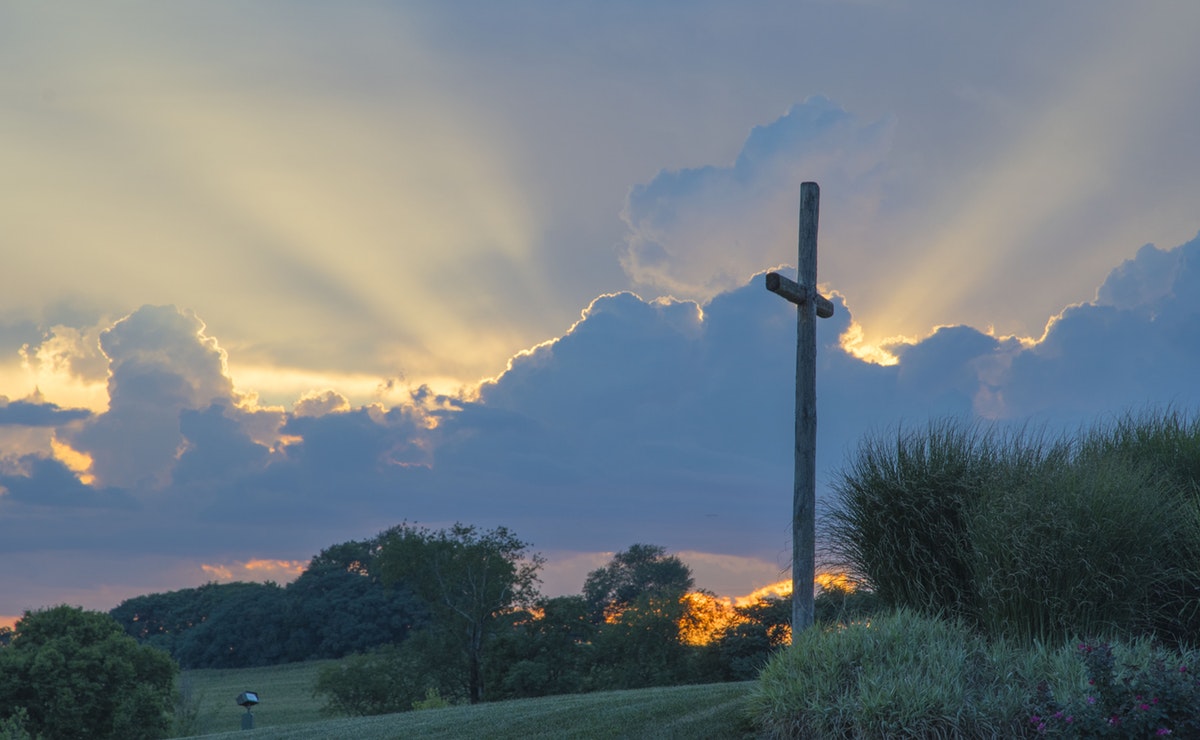 Cross on a hill infront of a sunset