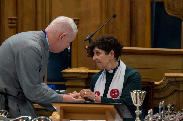 The Moderator receiving communion bread