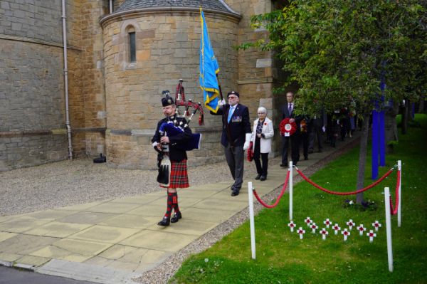 Piper Mark Macrae leads the Service of Dedication party to the Blackhall St Columba's war memorial.