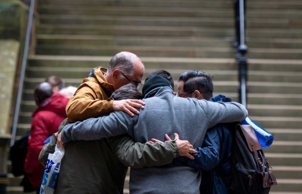 A group of General Assembly attendees embracing