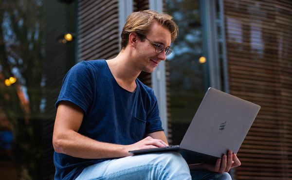 Person seated looking at laptop