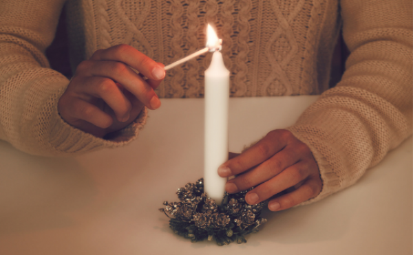 A lady's hands lighting a candle for Advent