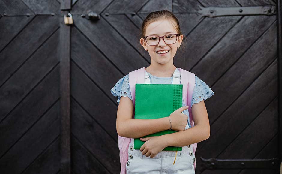 Smiling girl in front of wooden door