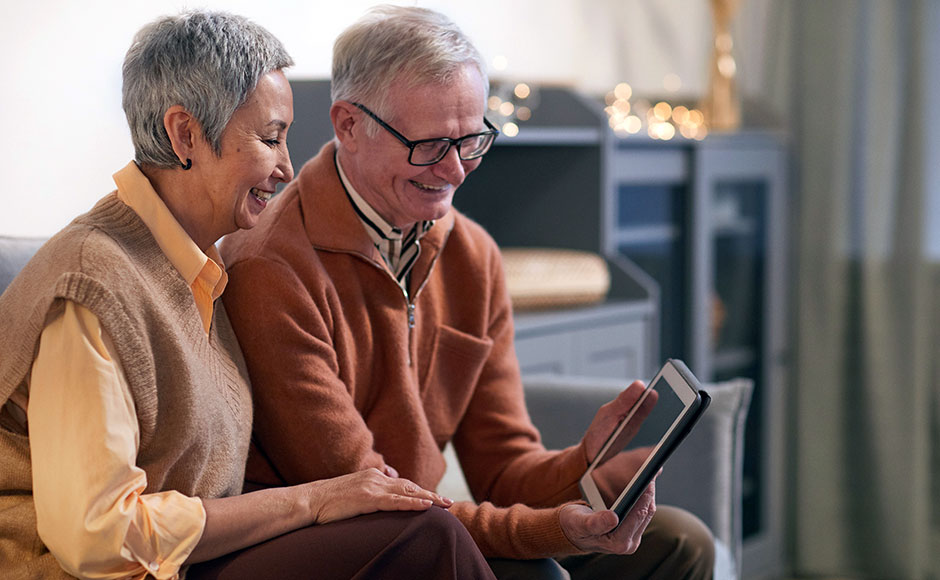 A couple looking at a tablet device