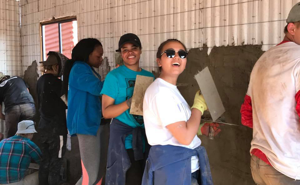 Applying the first coat of cement mixture.