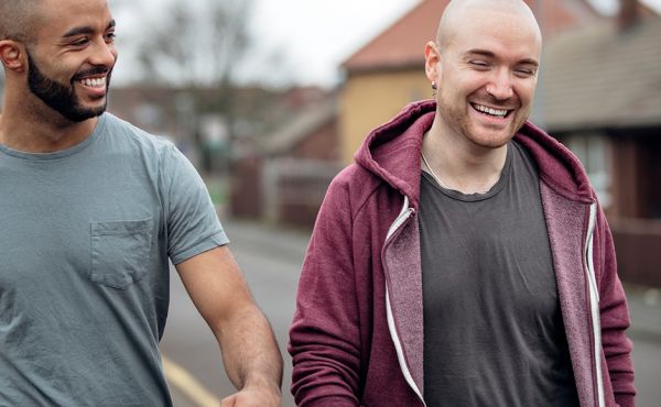 two men from different ethnic backgrounds walking together