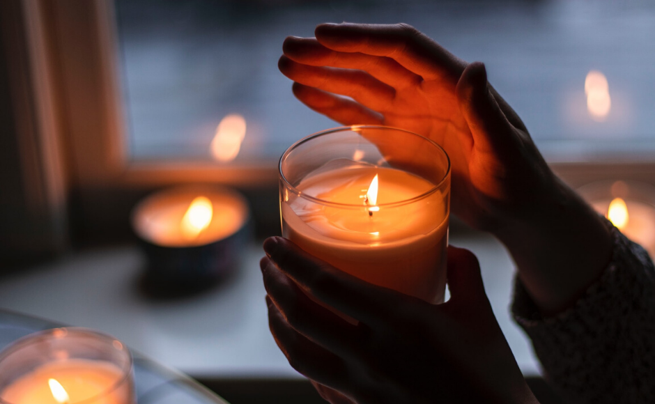 Hands holding a candle