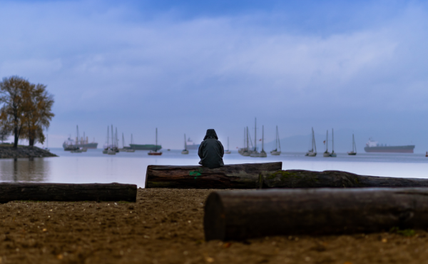Woman sitting alone on a beach