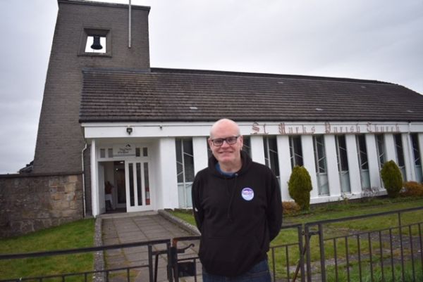 Rev Barry Hughes standing outside St Mark's Church, Raploch.