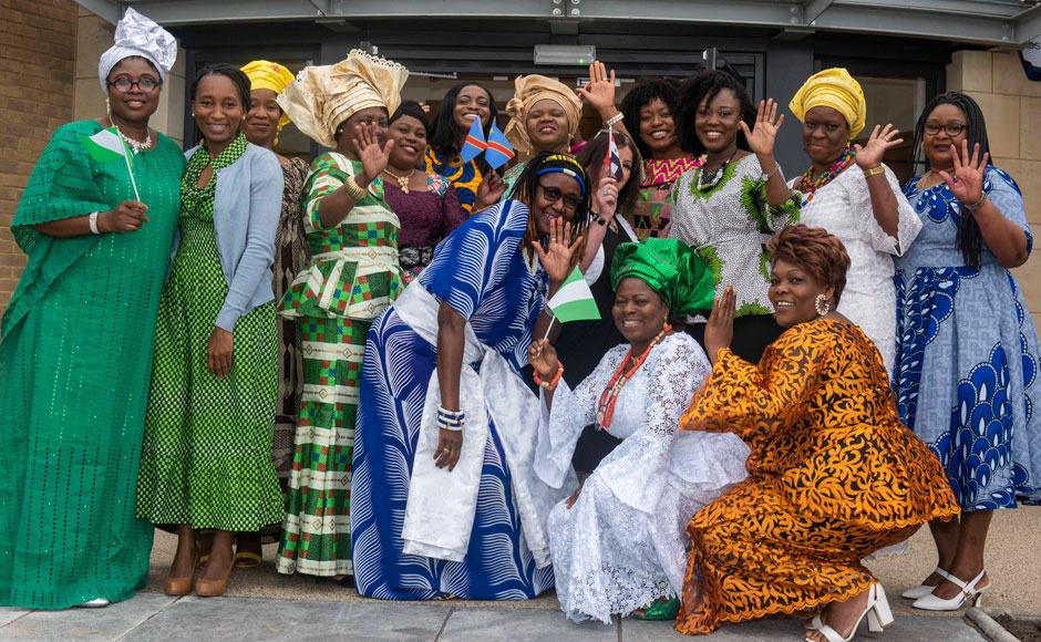 A group of ladies in colourful outfits outside the St Rollox Church in Glasgow