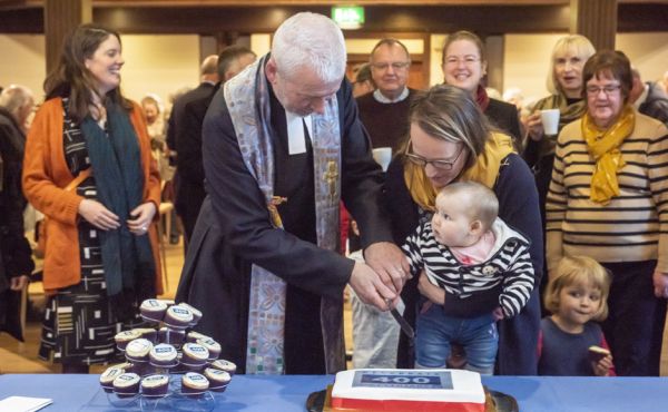 Rev Richard Frazer cutting a cake